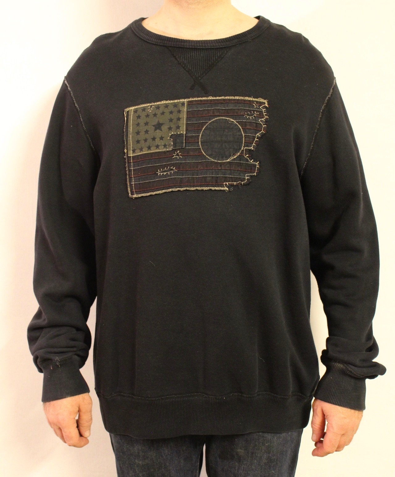 Ralph Lauren Polo Jeans Co. vintage sweatshirt. Black crew neck pullover with distressed US flag patch. Round neck jumper