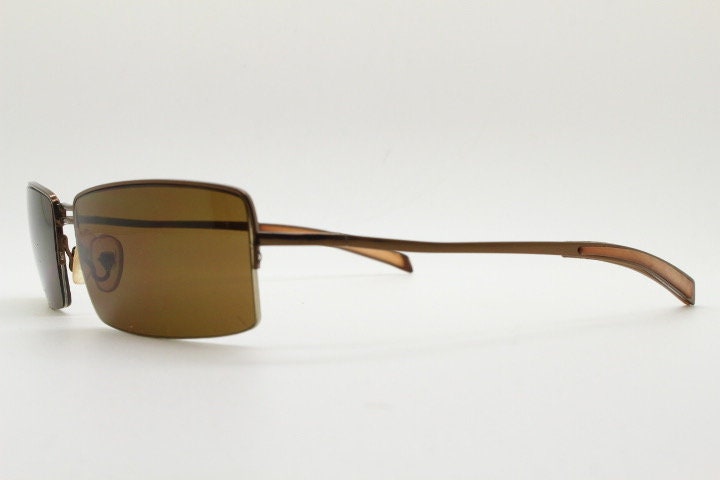 Y2K vintage curved rectangular sunglasses. Minimal half frame in brown chrome with mid tone lenses and straight arms. 2000's. 00's NOS