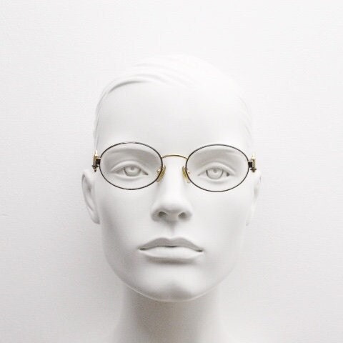 Gianfranco Ferre 90s vintage oval eye glasses made in Italy. Black and gold metal tech design optical frame. Prescription RX. NOS
