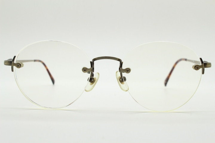 Edwin vintage 90s frameless round eye glasses model 59392A made in Japan. Minimal satin bronze finish optical frame. Prescription RX
