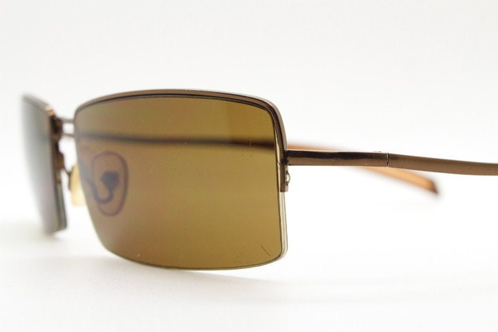 Y2K vintage curved rectangular sunglasses. Minimal half frame in brown chrome with mid tone lenses and straight arms. 2000's. 00's NOS