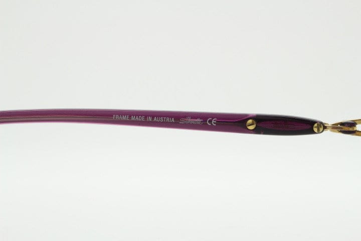 Silhouette oval half frame eye glasses model 6566 made in Austria. Minimal optical frame with gold trim deep purple arms. Prescription RX