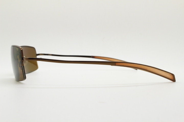 Y2K vintage curved rectangular sunglasses. Minimal half frame in brown chrome with mid tone lenses and straight arms. 2000's. 00's NOS