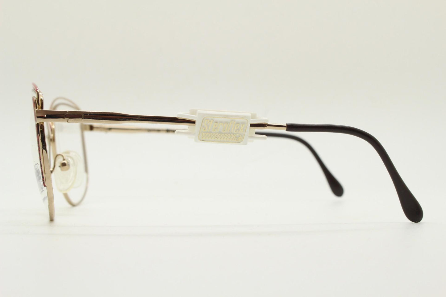 Luxottica 80s vintage gold metal eye glasses made in Italy. Inventive double brow with red highlights. Optical frame. Prescription NOS