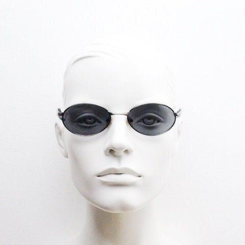 90s vintage small oval  bug eye sunglasses. Brushed bronze finish frame with transparent grey arms. Y2K. 2000s. Unworn NOS