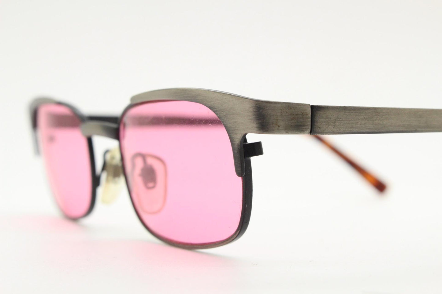 90s vintage rectangular sunglasses with bright pink lenses. Solid metal low profile frame in a brushed bronze finish. Y2K. NOS