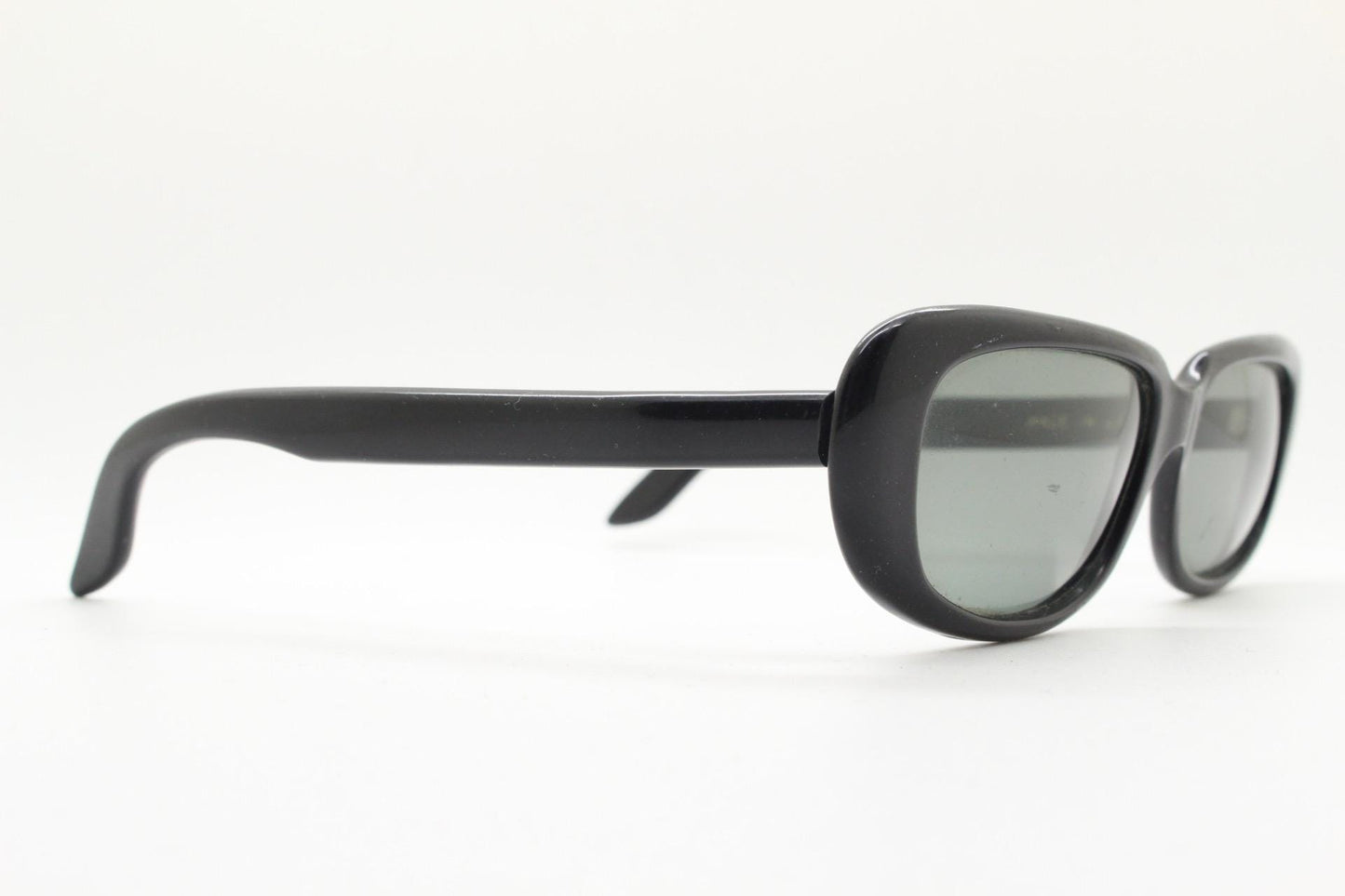 Polaroid 60s vintage rectangular sunglasses made in England. Authentic plain black frame with atmospheric curved lenses. Mens mod