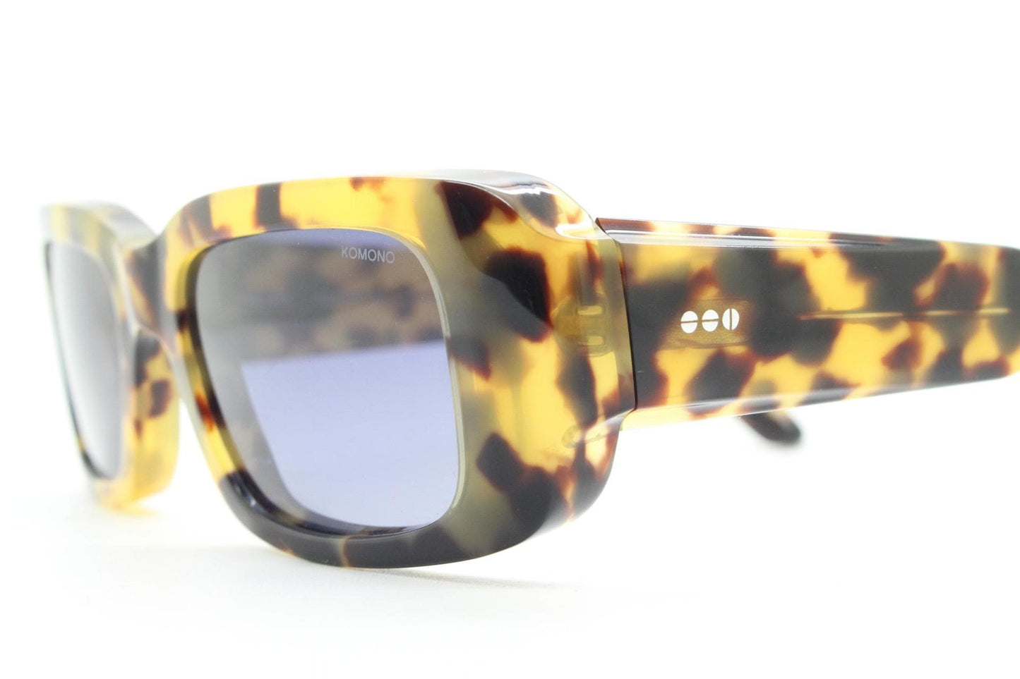 Komono chunky rectangular sunglasses model The Wes. Thick framed honey tortoise eco acetate with curved back 'goggle' sides and tall arms.
