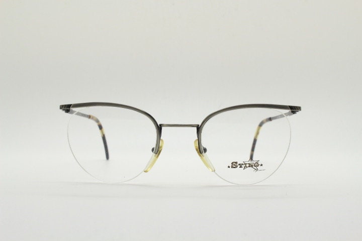 Sting 90s vintage round eye glasses. Minimal pewter finish metal half frame brow line optical frames. Prescription eyeglasses. RX. NOS