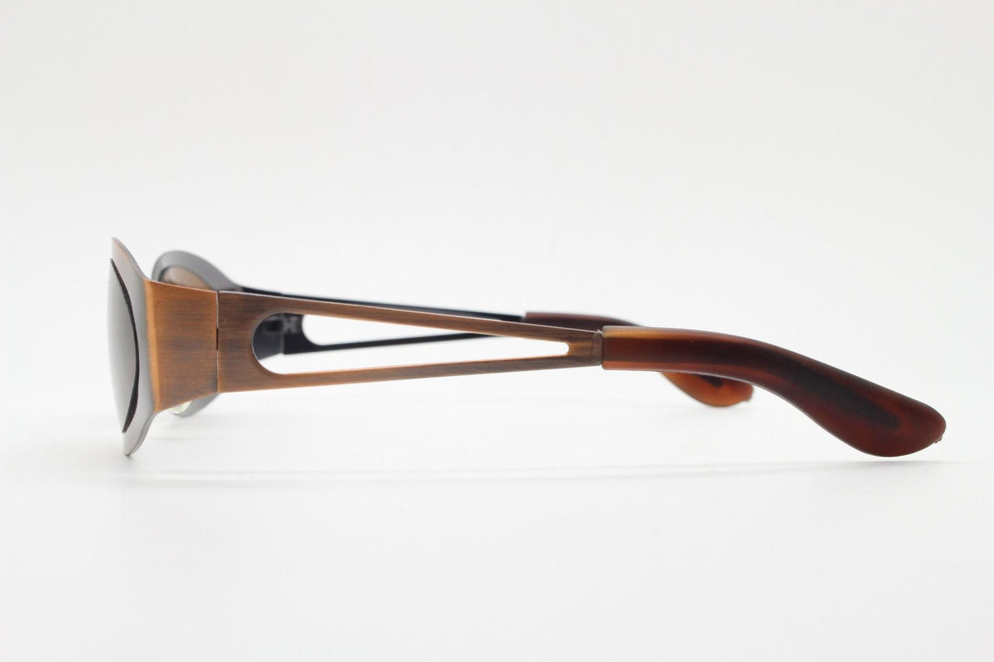 2000s vintage wraparound angular sunglasses. brushed copper finish flat curved metal frame with cut out arms. 90s. Y2K unused NOS