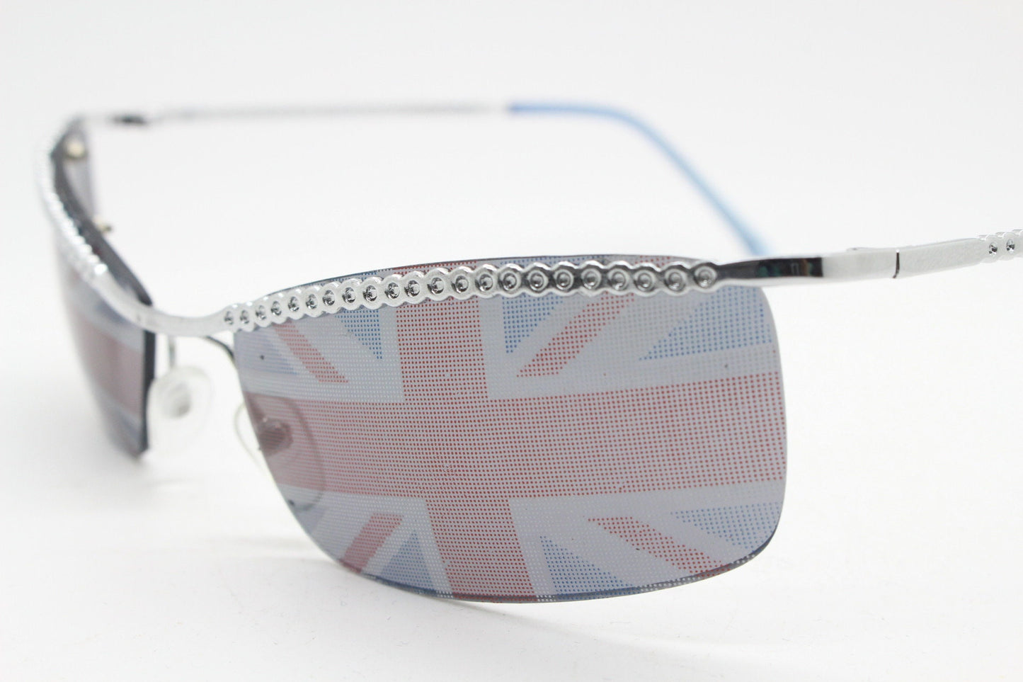 90s vintage half frame Union Jack sunglasses. Curved lens suspended on a sparkling chrome brow. Unused NOS. Brit pop girl power