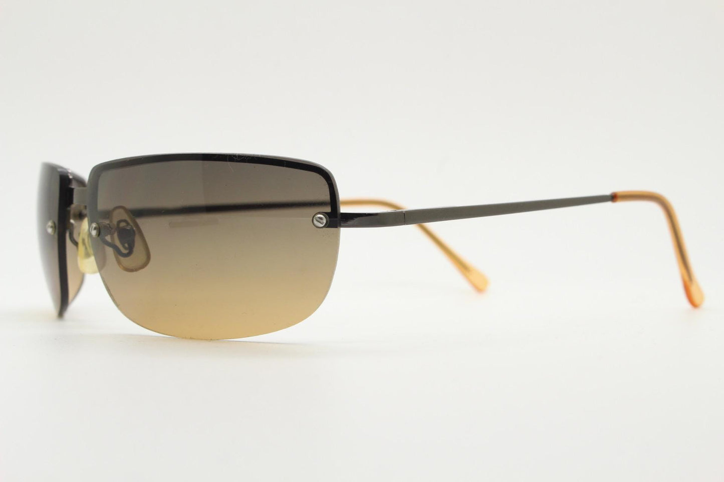 Y2K vintage curved rectangular sunglasses. Minimal half frame in brown chrome with grey to amber fade lenses. 2000's. 00's NOS