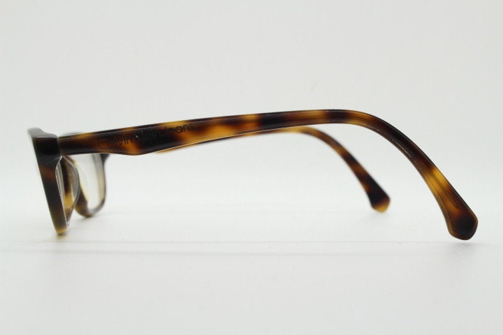 Calvin Klein Jeans modified cat eye glasses model CKJ918. Tortoise gloss low profile acetate optical frames. Prescription eyeglasses. RX