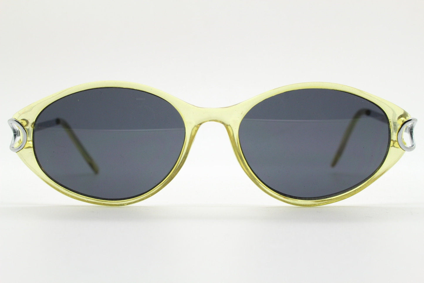 Carven Paris 90s vintage oval sunglasses. Womens transparent yellow frame with black lenses and silver metal arms. NOS
