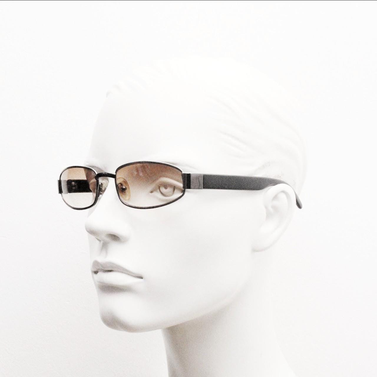 90s vintage oval sunglasses small bug eye with light tone lenses. Satin finish brown metal frame with black arms. 2000's. NOS