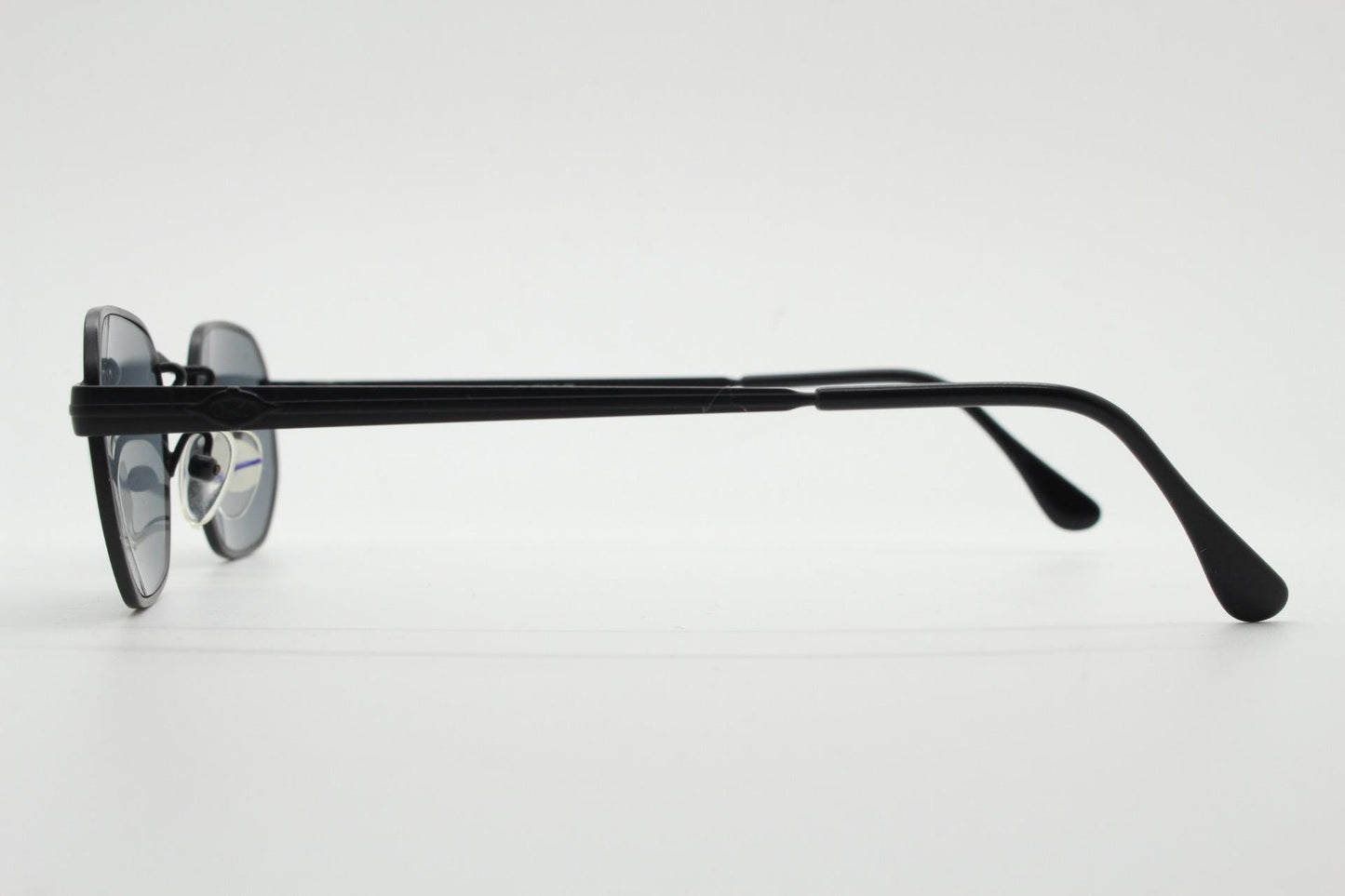 Prestige 90s vintage small oval sunglasses model 119 made in Italy. Black matt metal frame with with subtle angular facets, NOS octagon