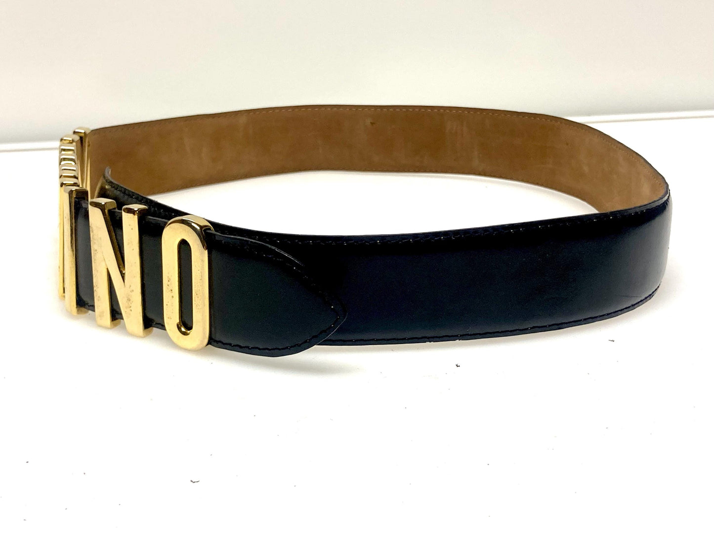 Moschino 90s vintage womens dress belt in black genuine leather. Iconic individual golden moving letters logo. Made in Italy. 80s. NOS