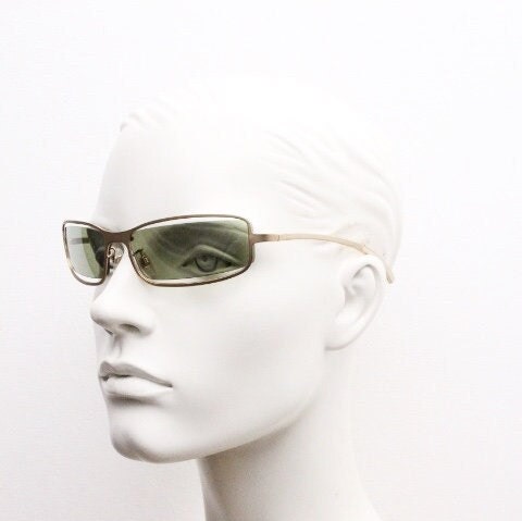 Y2K vintage wraparound sunglasses. Low profile satin finish golden slender frame with green lenses and gap feature. 2000's. 90s. NOS