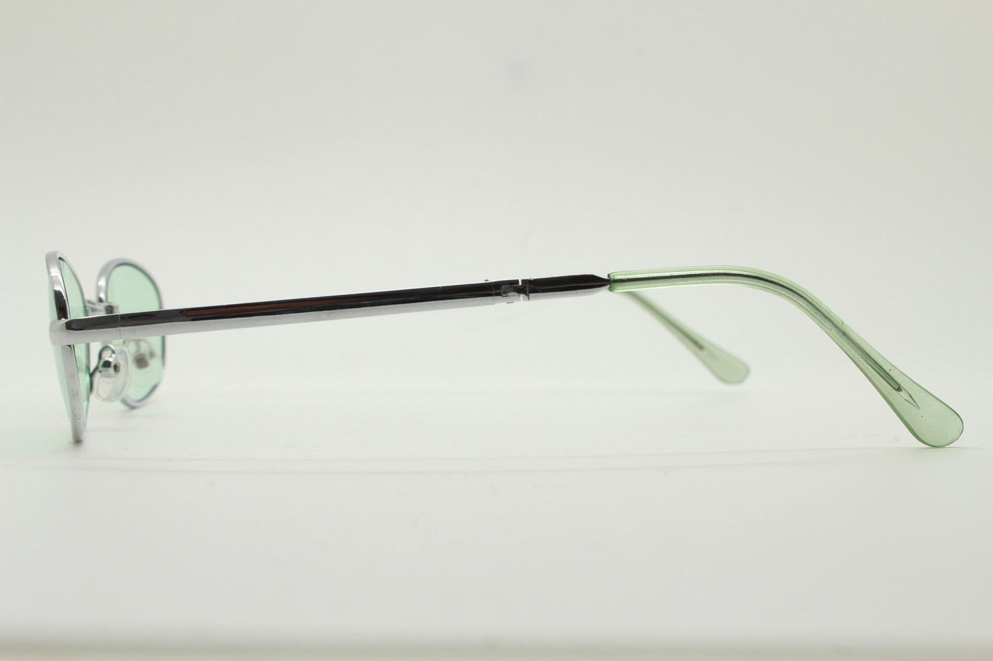 90s micro foldable oval sunglasses. Light green lenses in a small silver folding compact frame. Folder. Rave 2000s. Y2K. NOS