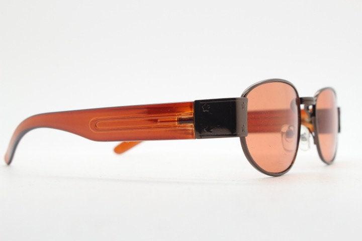 90s vintage low profile sunglasses. Brown chrome frame with thick transparent amber arms and orange lenses. Unused. BNWT