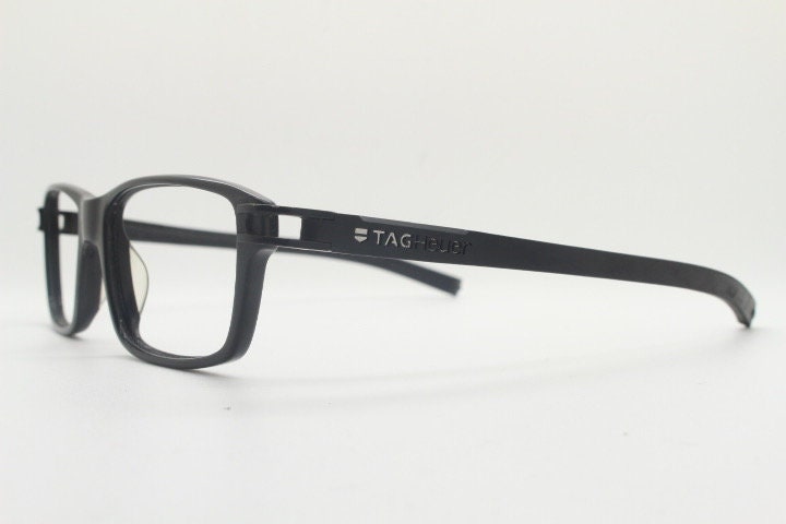 Tag Heuer rectangular eye glasses. Patented design made in France. Solid acetate optical frame with flexible rubber arms. Prescription RX