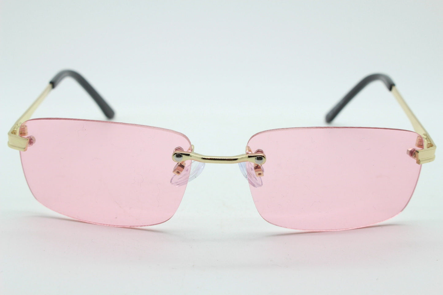 Y2K vintage frameless pink sunglasses. Rectangular lenses with gold bridge and arms. 2000s club kids. 00's. 90s Rave