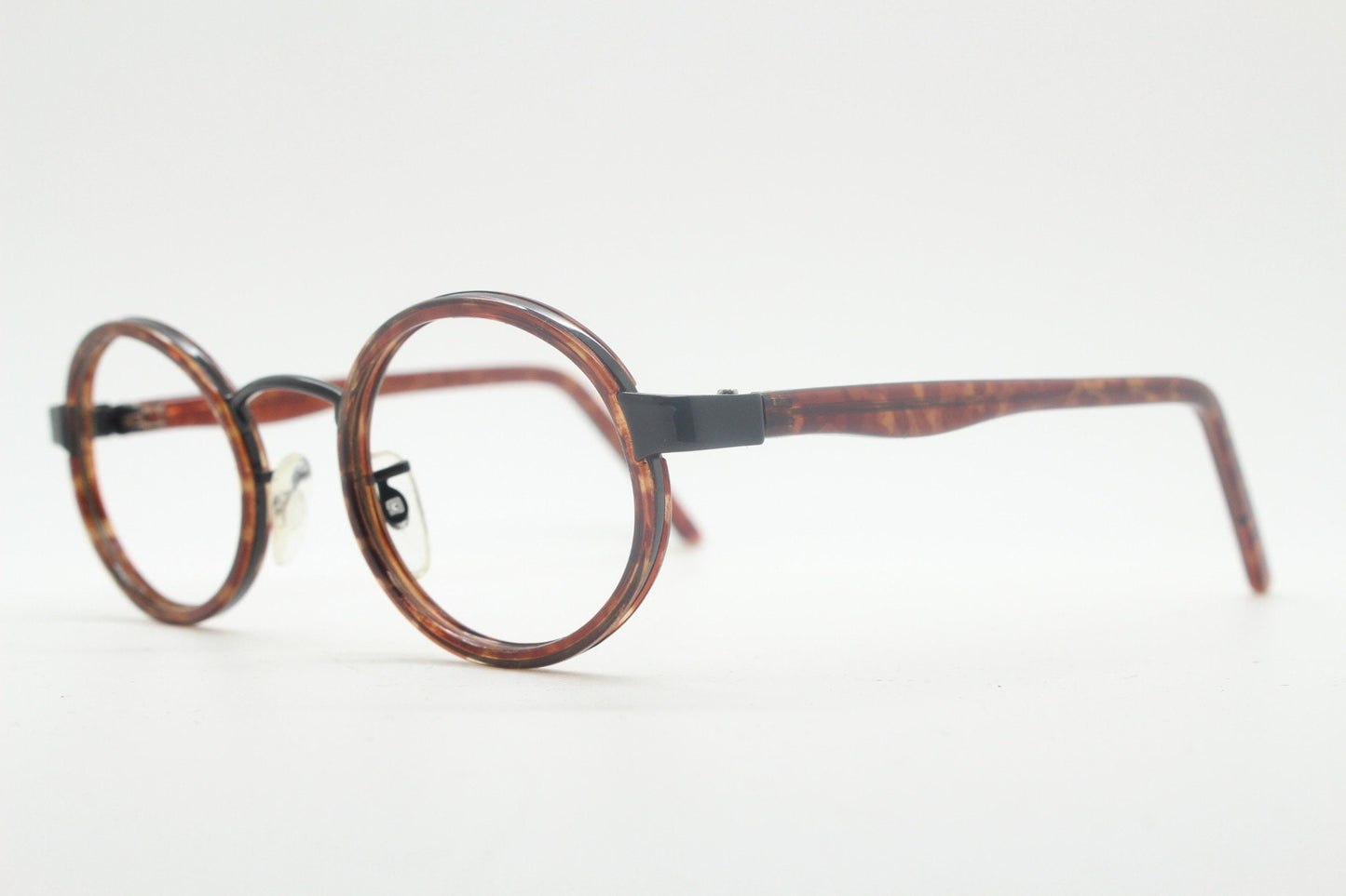 90s vintage oval glasses. Minimal slim black optical frame encasing tortoise inserts. 40s, 50s style prescription eyeglasses. RX spectacles