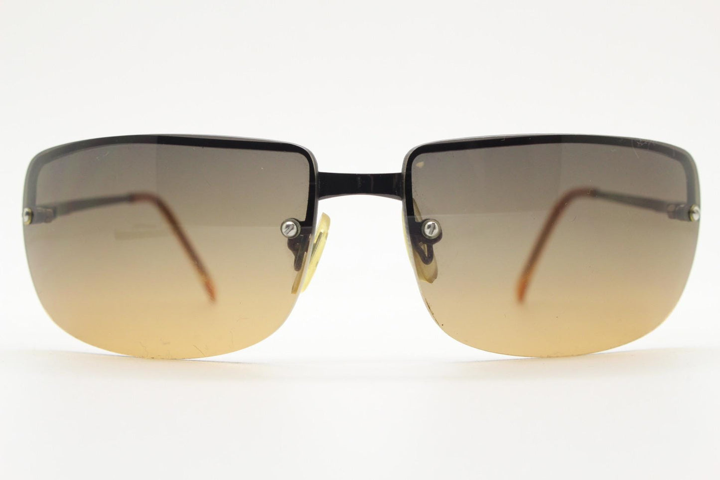 Y2K vintage curved rectangular sunglasses. Minimal half frame in brown chrome with grey to amber fade lenses. 2000's. 00's NOS