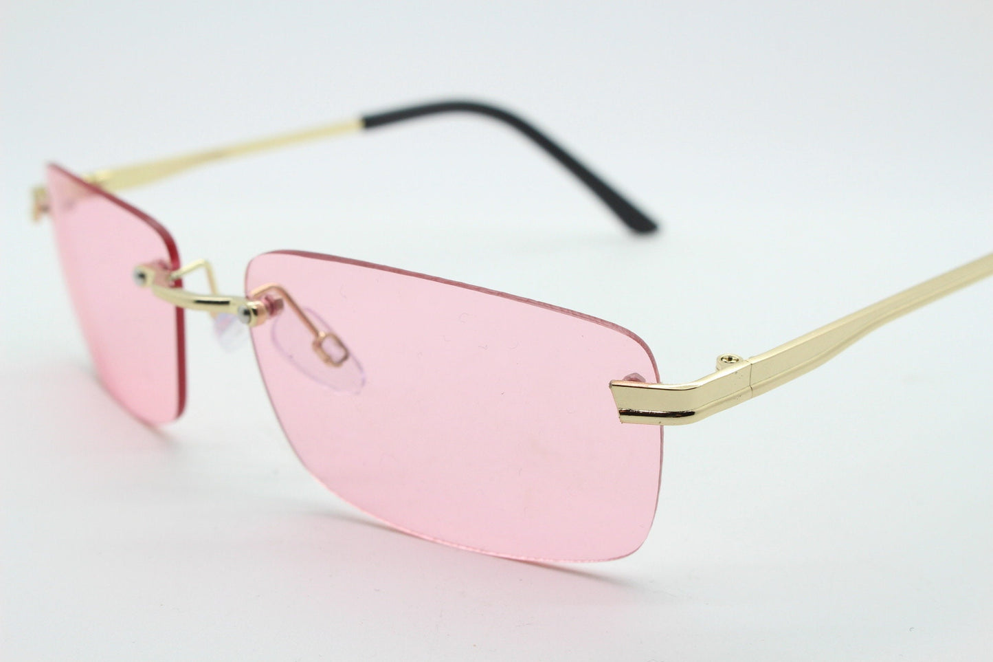 Y2K vintage frameless pink sunglasses. Rectangular lenses with gold bridge and arms. 2000s club kids. 00's. 90s Rave