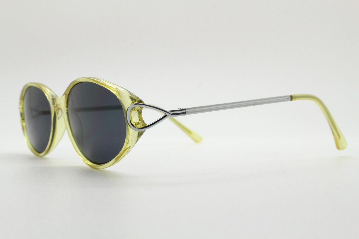 Carven Paris 90s vintage oval sunglasses. Womens transparent yellow frame with black lenses and silver metal arms. NOS