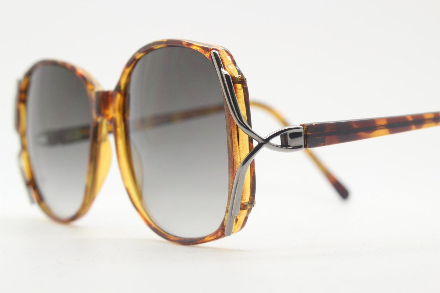 80s vintage square sunglasses. Womens honey tortoise frame with dynamic metal  forked side joints and graduating lenses. 70s. Unused NOS