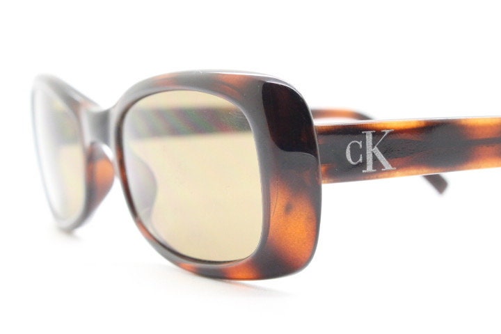 Calvin Klein 90s vintage thick framed rectangular sunglasses. Womens dark tortoise gloss low profile design.