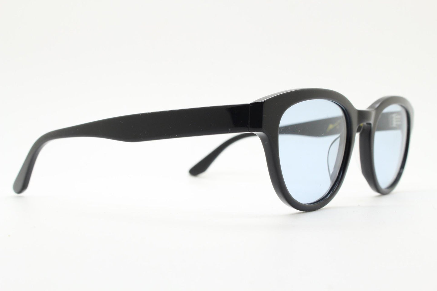 Vintage modified wayfarer design sunglasses. Black gloss acetate frame with extra light tone blue lenses in ideal proportions. NOS