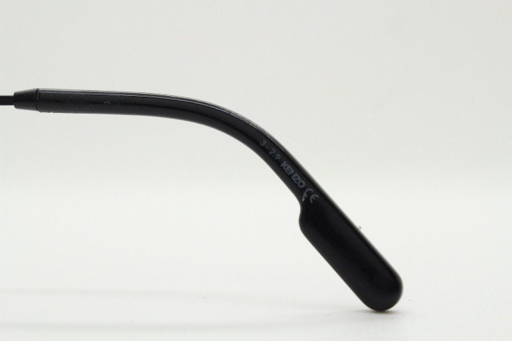 Kenzo flat screen triangular futuristic cat eye. Slight mirror glaze mono lens on black matt metal wire frame. NOS Cateye