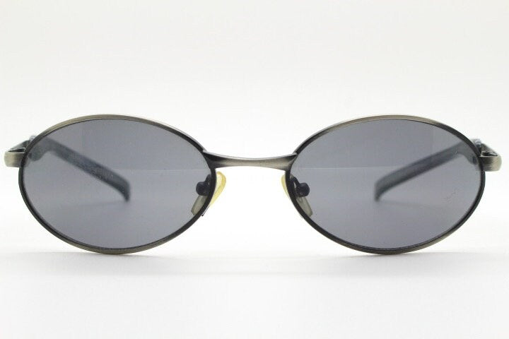 90s vintage small oval  bug eye sunglasses. Brushed bronze finish frame with transparent grey arms. Y2K. 2000s. Unworn NOS