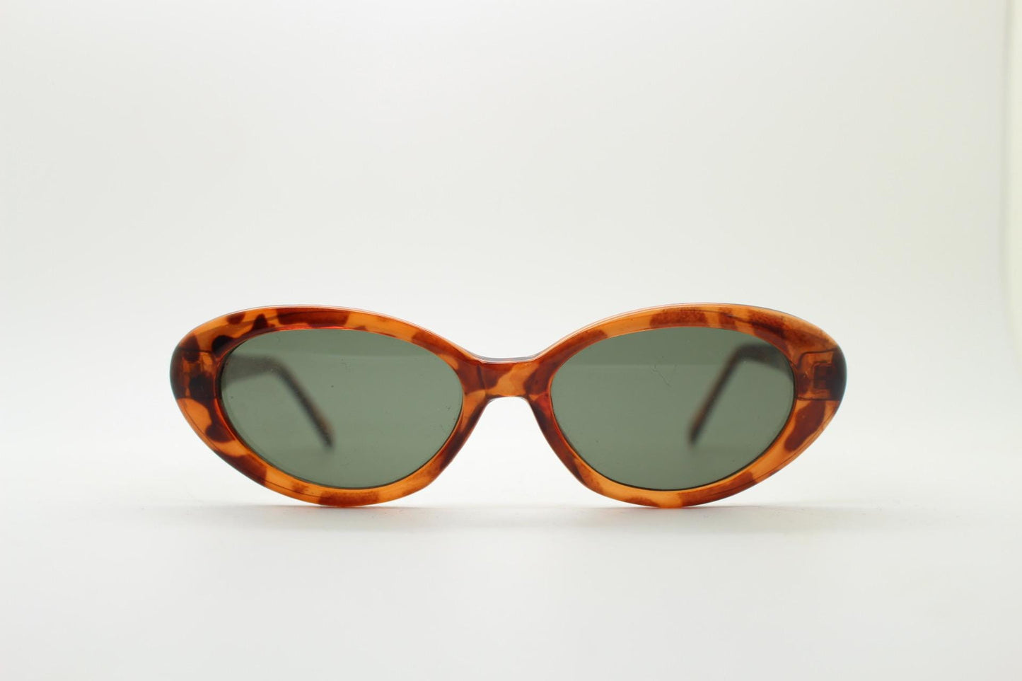 Vintage 90s oval cat eye sunglasses. Vibrant amber tortoise quality acetate frame in neat proportions with green lenses. Womens NOS