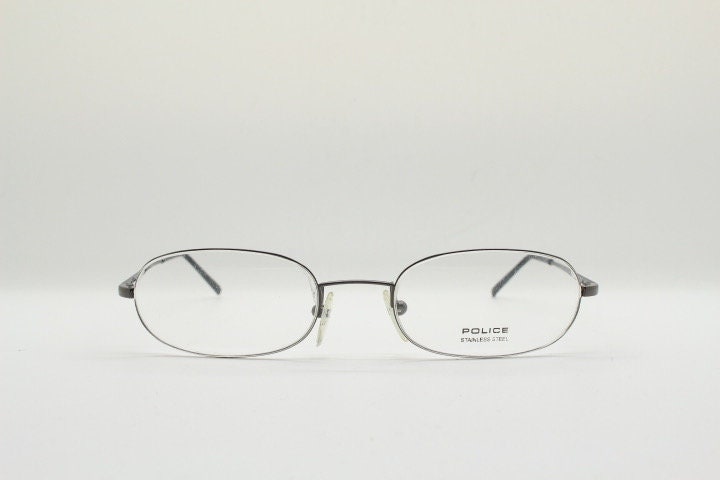 Police 90s vintage oval half rim eye glasses made in Italy. Minimal lightweight optical frame in gunmetal grey. Prescription RX Spectacles