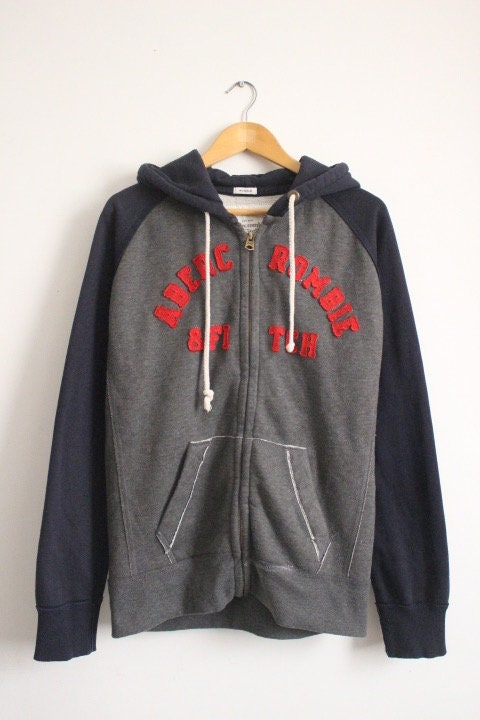 Abercrombie and Fitch grey and blue zipper sweat hoody with large red spell out patch letter chest logo. Mens all cotton medium size