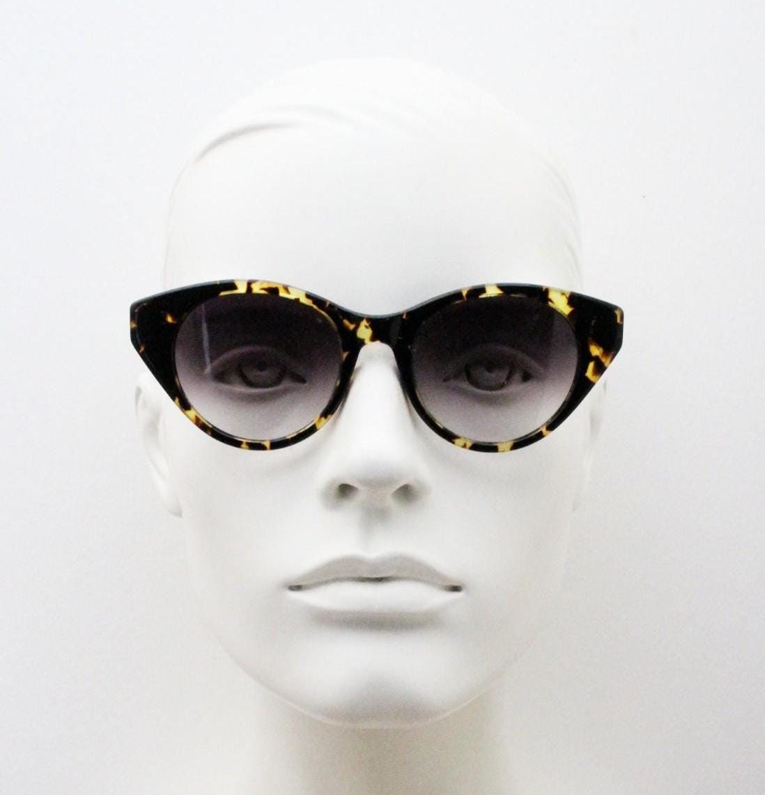 Barton Perreira subtle cat eye sunglasses model kismet. Honey tortoise acetate frame with cropped sides and graduating lenses