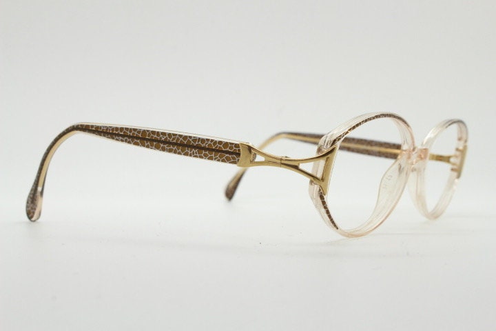 Silhouette 80s vintage oval eye glasses made in Austria. Transparent crystal optical frame with giraffe arm print. Prescription RX