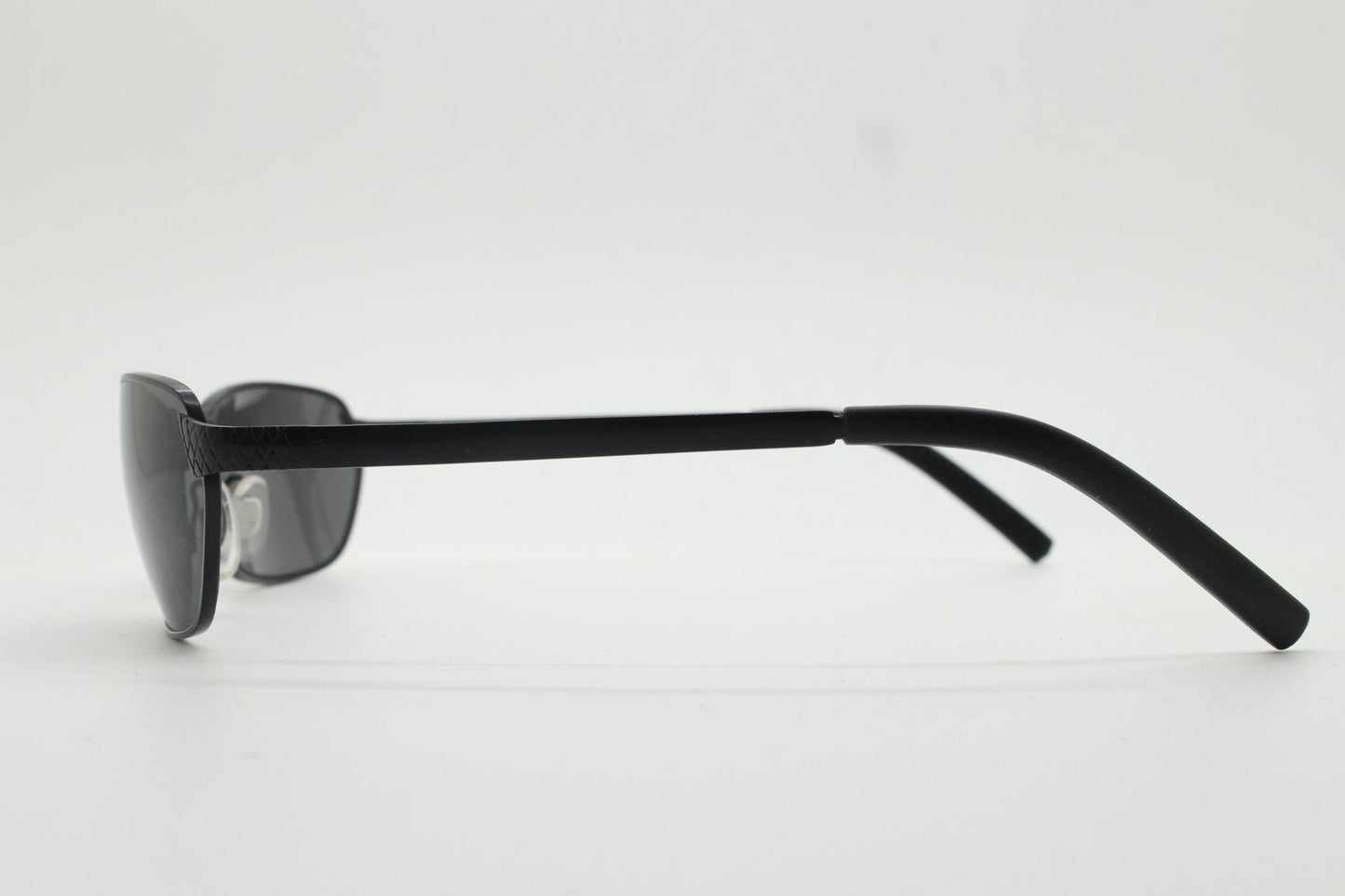 90s vintage wraparound sunglasses. Black satin finish on rectangular frame with unassuming style details. 2000's. Y2K. Unused NOS bug eye