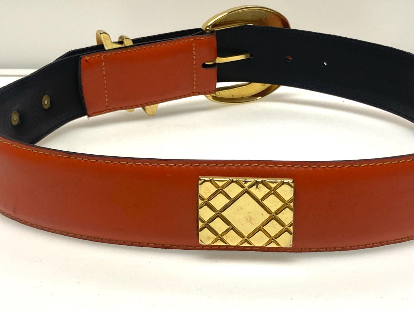 80s vintage womens dress / jeans belt in bright orange leather with golden metal squares. Made in France. Used in good condition