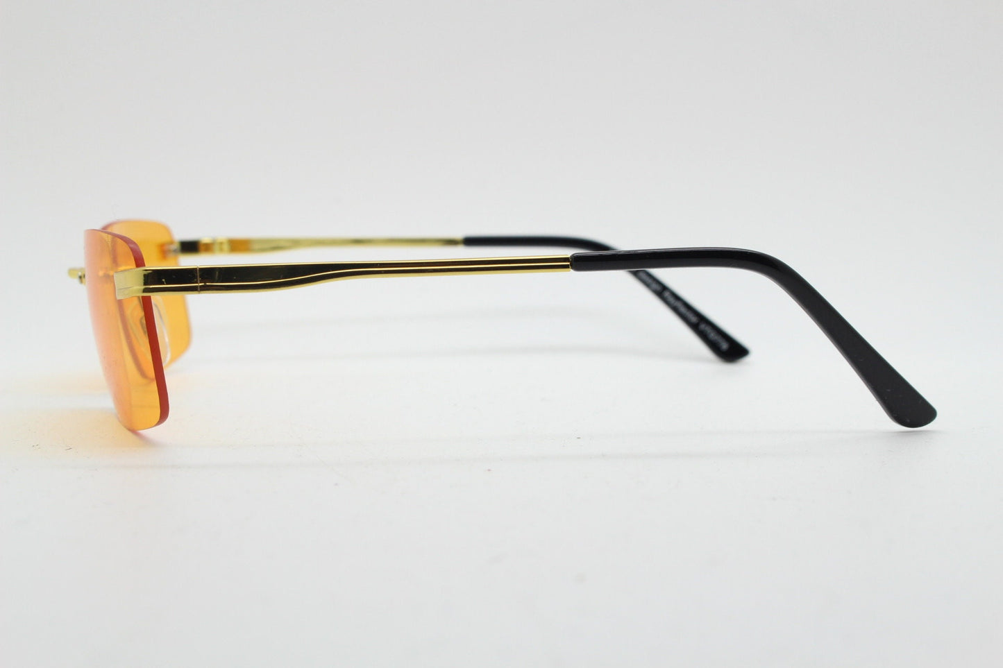 Y2K vintage frameless orange sunglasses. Rectangular lenses with gold bridge and arms. 2000s club kids. 00's. 90s Rave