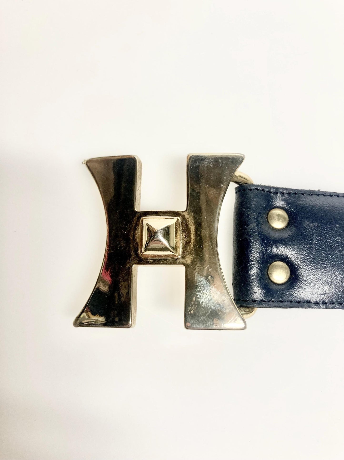 80s vintage womens dress belt in navy blue genuine leather with substantial gold chrome studded 'H' motifs. Made in France. Size S