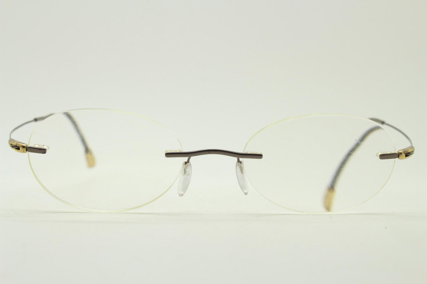 Silhouette vintage oval frameless eye glasses made in Austria. Minimal lightweight satin bronze optical frame. Prescription spectacles