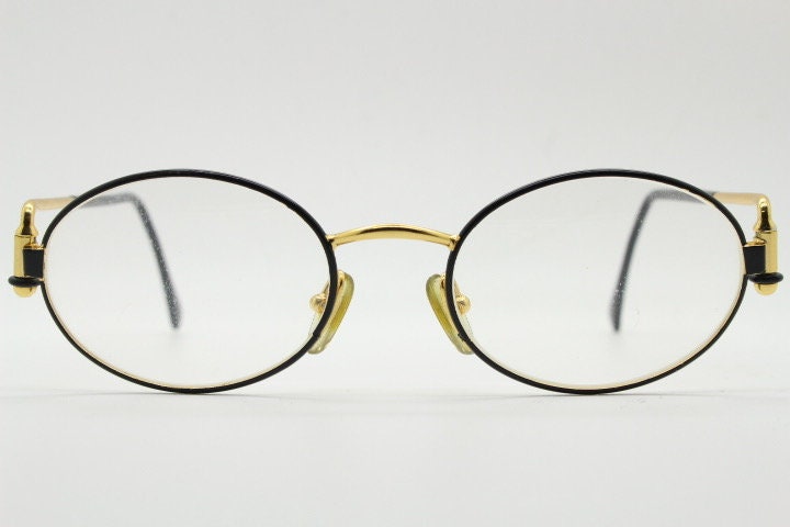 Gianfranco Ferre 90s vintage oval eye glasses made in Italy. Black and gold metal tech design optical frame. Prescription RX. NOS