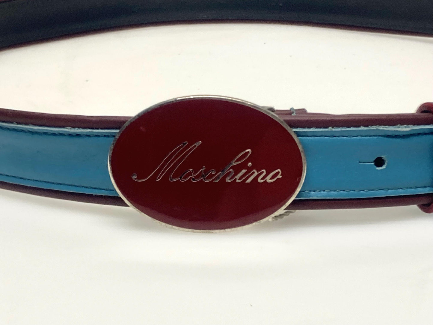 Moschino 90s vintage womens dress belt in oxblood and blue genuine leather with oval enamelled metal buckle. Made in Italy. BNWT. NOS