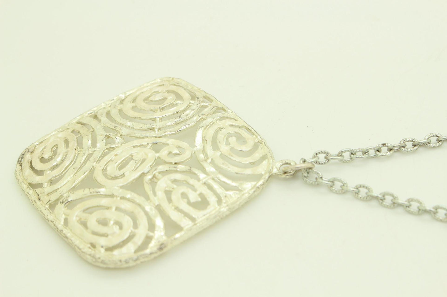 60s vintage large silver square pendant necklace made in England. Satin and matt finish with swirling paisley cut out shapes. Womens. NOS