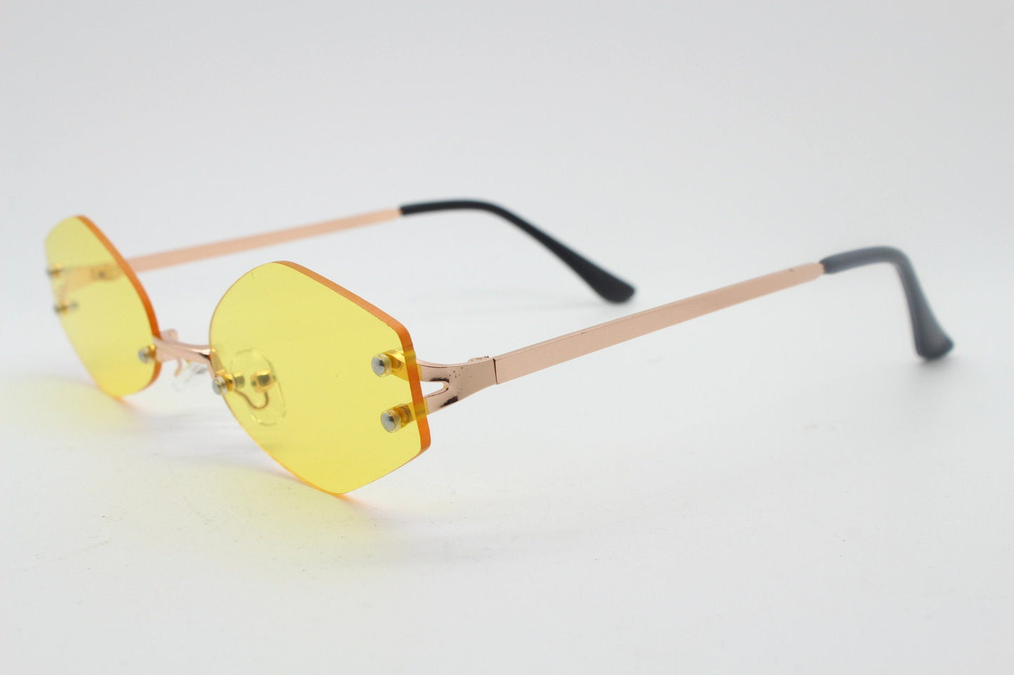 Y2K vintage frameless hexagon sunglasses. Bright yellow lenses with rose gold bridge and arms. 2000s, 00's. 90s