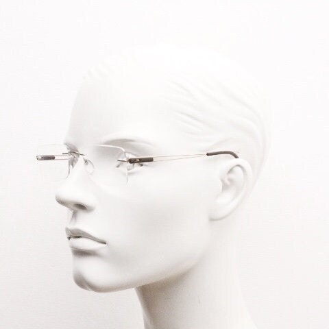 Silhouette rectangular frameless eye glasses model 7677 made in Austria. Minimal lightweight optical frame with golden trim. Prescription RX